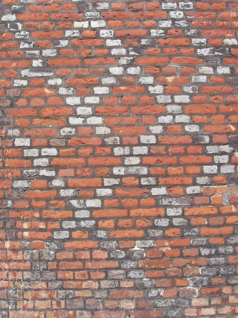 Another brick wall with a pattern.